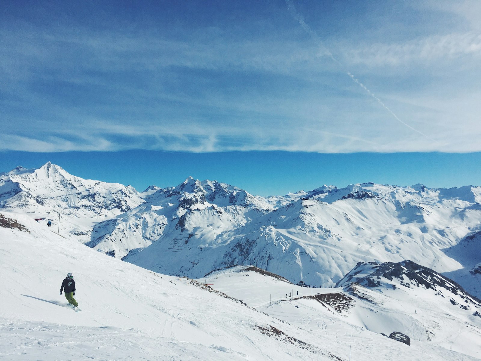 Snowboarder above the clouds on the Grande Motte glacier in Tignes