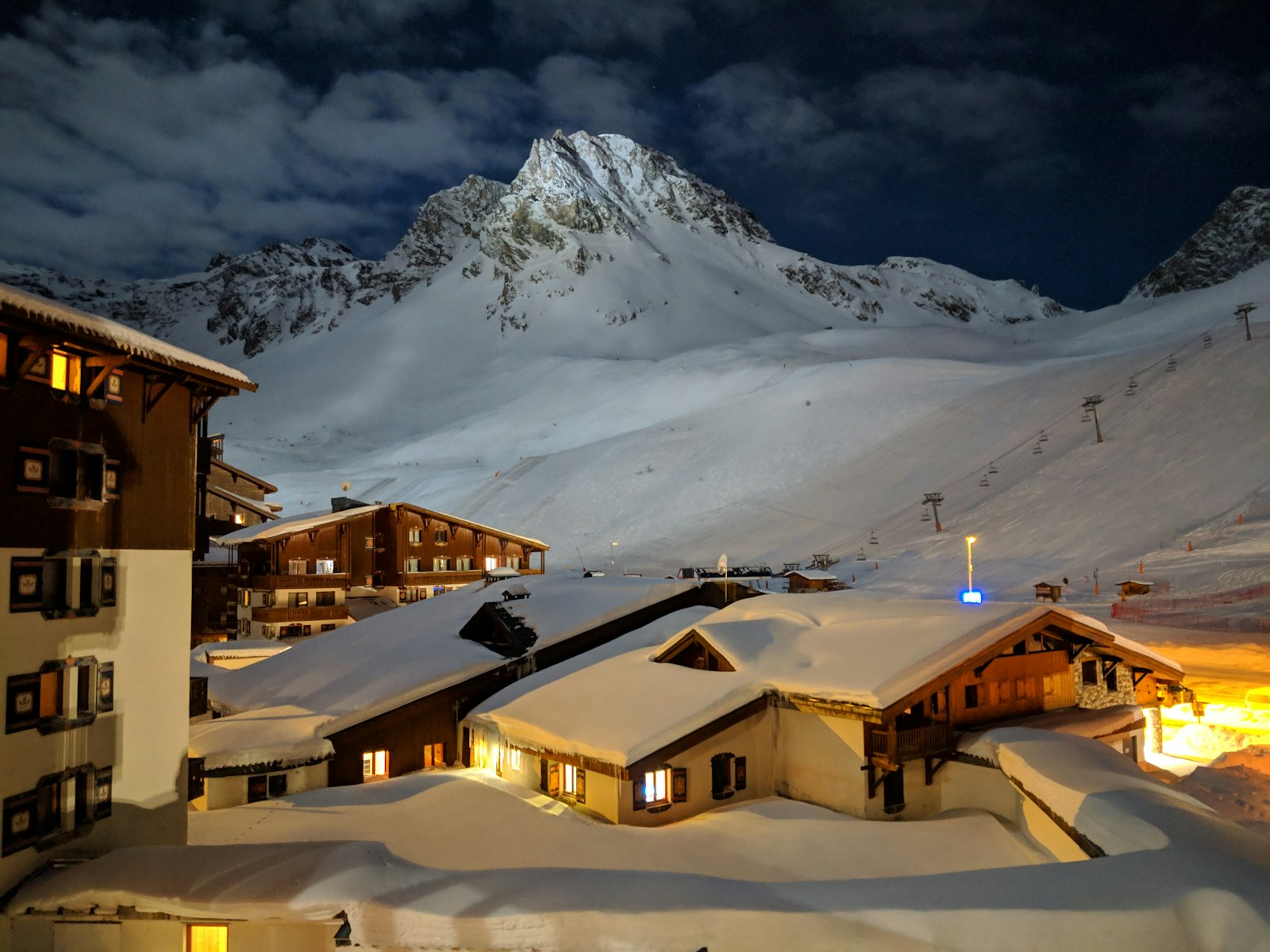 Snow-covered hotels and chalets of Tignes lit up at night