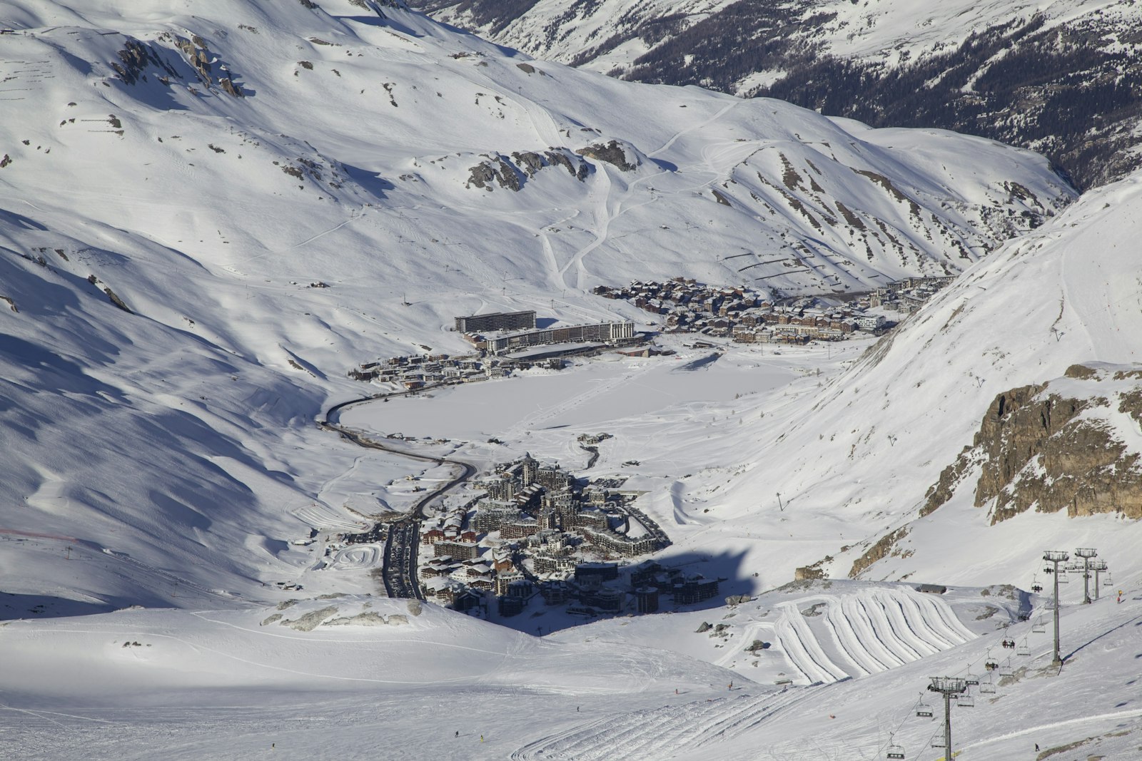 Aerial view of the villages of Tignes and the frozen lake in winter, French Alps